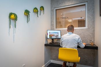 a man sitting at a desk in front of a computer at Union 346, Massachusetts, 02143
